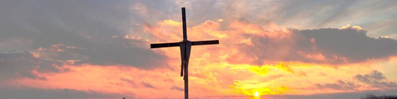 Cross with sunset in the background.